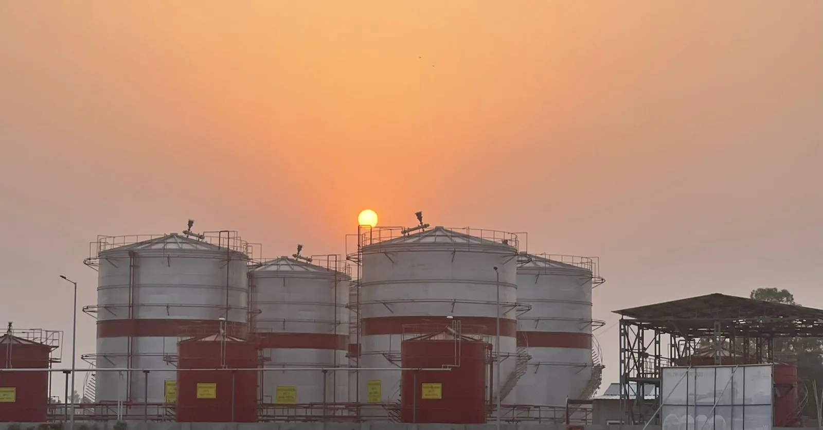 Industrial Storage Tanks at Sunset